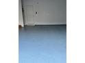 Garage with light-blue epoxy floor and a door to the house at 3144 Spicy Cedar Ln, Lithonia, GA 30038