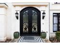 Elegant black double front doors with ornate ironwork at 3000 Leeds Garden Ln, Alpharetta, GA 30022
