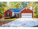 Red brick home with a white garage door at 2322 Sheridan Ct, Villa Rica, GA 30180