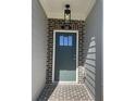 Inviting entryway with a dark teal door and brick accents at 269 Lakeside Pl, Canton, GA 30114