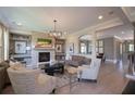 Bright living room with stone fireplace, built-in shelving, and hardwood floors at 11360 Bennett Ln, Johns Creek, GA 30097