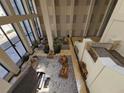High-ceiling lobby with seating, plants, and natural light at 1280 W Peachtree W St # 1407, Atlanta, GA 30309