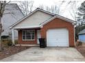 Ranch style home with a covered porch, brick facade, and attached garage at 6627 Coventry Pt, Austell, GA 30168