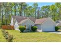 Charming home with well-maintained lawn, mature trees, and inviting curb appeal at 10252 Commons Xing, Jonesboro, GA 30238
