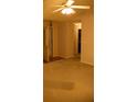 Bright living room features a ceiling fan and an open doorway at 10252 Commons Xing, Jonesboro, GA 30238