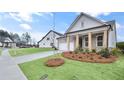 Side view of an attractive home featuring a brick facade and lush green landscaping at 161 Mooney Rd, Woodstock, GA 30188