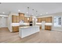 Spacious kitchen with an island, granite countertops, stainless steel appliances, and modern lighting at 161 Mooney Rd, Woodstock, GA 30188