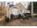 Tan house with white accents, three-car garage, and landscaping at 3502 Rain Tree Ct, Douglasville, GA 30135