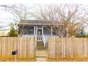 House with a wooden fence and a walkway to the front door at 744 Law Nw St, Atlanta, GA 30318