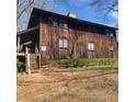 Wood exterior of a two-story home with a sloped yard and minimal landscaping at 7 Quail Run, Decatur, GA 30035