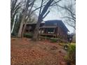 Two-story home with wood siding, multiple decks, and mature trees surrounding the property at 7 Quail Run, Decatur, GA 30035
