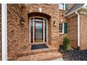 Elegant front door with brick entryway and lighting at 879 Ector Chase Nw, Kennesaw, GA 30152