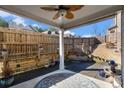 Inviting covered patio with a ceiling fan, stylish rug and peaceful water fountain at 202 Bryon Ln, Acworth, GA 30102
