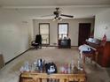 Spacious living room with a ceiling fan, piano, and ample natural light at 804 Bankshire Dr, Suwanee, GA 30024