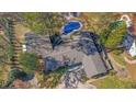 Aerial view of home showcasing the roof, back yard with pool, spa, and landscaping at 505 River Valley Rd, Sandy Springs, GA 30328