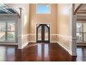 Two-story foyer with hardwood floors and elegant door at 4361 River Vista Rd, Ellenwood, GA 30294