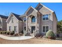 Two-story brick home with an ornate entryway and landscaping at 4361 River Vista Rd, Ellenwood, GA 30294