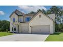 Two story house with light brick exterior, three car garage, and landscaped lawn at 211 Linford Dr, Locust Grove, GA 30248