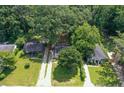 Aerial view of a cozy home with a long driveway nestled among lush green trees at 1256 Elizabeth Ave, Atlanta, GA 30310