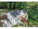 Exterior of a quaint house with a stone chimney, showcasing a well-maintained yard at 1256 Elizabeth Ave, Atlanta, GA 30310