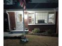 Brick house exterior at night with an American flag at 1577 Dellwood Circle, Morrow, GA 30260