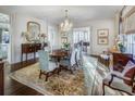 Formal dining room with a large table, chandelier, and hardwood floors at 2583 Habersham Nw Rd, Atlanta, GA 30305