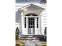 Elegant front entry with a light blue door, white columns, and brick steps at 2583 Habersham Nw Rd, Atlanta, GA 30305