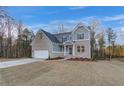 Two-story home with gray siding, brick accents, and a three-car garage at 508 Dolce Rd, Locust Grove, GA 30248