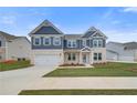 New two-story home boasts a two-car garage, manicured lawn, stone accents, and navy blue siding at 203 Arabella Pkwy, Locust Grove, GA 30248