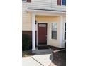 Front entrance with a dark brown door, white columns, and a small covered porch at 2374 Suwanee Pointe Dr, Lawrenceville, GA 30043