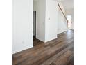 Inviting living room showcasing hardwood floors, white walls, and stairway at 2374 Suwanee Pointe Dr, Lawrenceville, GA 30043