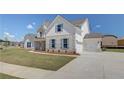 Two story home with light brick and siding, landscaping, and driveway at 443 Lothbury Ave, Locust Grove, GA 30248