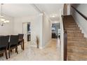 Bright and spacious foyer with tile floors and a staircase leading upstairs at 100 Orchard Ln, Covington, GA 30014