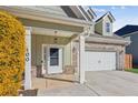 Inviting front entry with white door, brick columns, and lush yellow bushes at 100 Orchard Ln, Covington, GA 30014