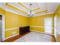 Formal dining room with hardwood floors and yellow walls at 3955 Three Chimneys Ln, Cumming, GA 30041