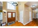 Bright two-story foyer with hardwood floors and double doors at 3955 Three Chimneys Ln, Cumming, GA 30041
