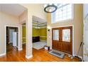 Two-story foyer with hardwood floors and double doors at 3955 Three Chimneys Ln, Cumming, GA 30041