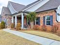 Brick and stone home with walkway and landscaping at 124 Sweetbriar Farm Rd, Woodstock, GA 30188