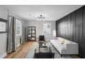Modern living room with a white couch and dark accent wall at 1534 Alma Sw St, Atlanta, GA 30311