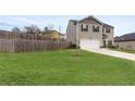 Spacious backyard with a wooden privacy fence and a patio at 3720 Liverpool Way, Atlanta, GA 30331