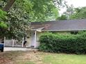 Ranch style home with a covered porch and mature landscaping at 1914 Bragg St, Brookhaven, GA 30341