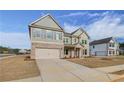 Stunning two-story home showcasing a brick and siding facade, as well as a spacious two-car garage at 501 Dolce Rd, Locust Grove, GA 30248