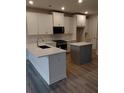 Modern kitchen with stainless steel appliances, white cabinets, gray island, and stone countertops at 1070 Crest Mill Dr, Marietta, GA 30008