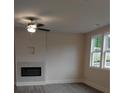 Bright living room featuring a fireplace with gray floors and large windows with tree views at 1070 Crest Mill Dr, Marietta, GA 30008