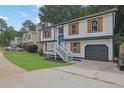 Front view of a two story house with landscaped lawn at 4913 Windsor Downs Dr, Decatur, GA 30035
