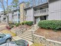 Condo building with stone fireplace and landscaping at 5031 Woodridge Way, Tucker, GA 30084