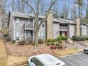 Condo building with balconies and wooded setting at 5031 Woodridge Way, Tucker, GA 30084