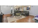 Spacious living room featuring a large sectional sofa and wood-look floors at 5031 Woodridge Way, Tucker, GA 30084