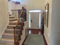 Two-story entryway with hardwood floors, an elegant staircase, and a view to living areas at 1814 Tristan Se Dr, Smyrna, GA 30080