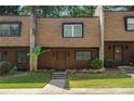 Brown townhome with landscaping and a walkway at 729 Cedar Pointe Sw Ct, Marietta, GA 30008